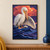White pelican with wings spread above a small folded-paper boat amid blue waves and coral clouds.; frame shown for styling only