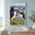 Two puffins with colorful beaks share a dangling red strand on a grassy rocky coast above the ocean.; frame shown for styling only