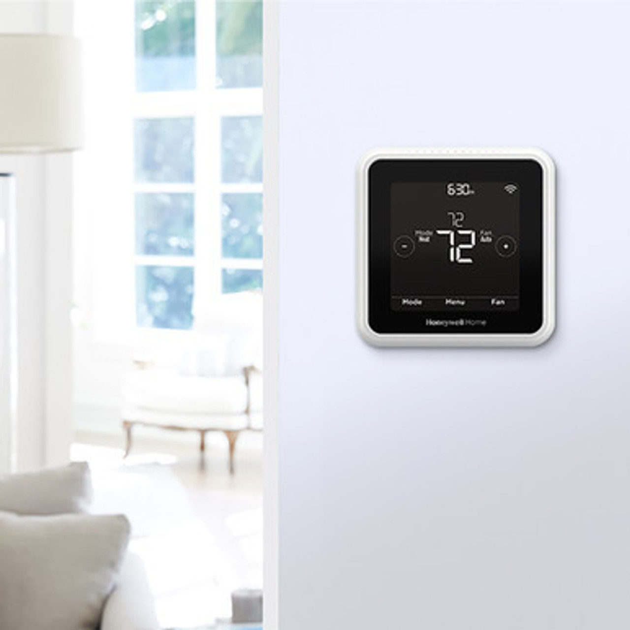 T5 Gen 2 Thermostat on wall with living room in the background