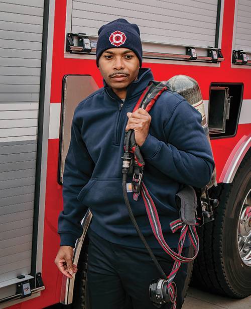Firefighter with a custom firefighter hat carrying an airpack