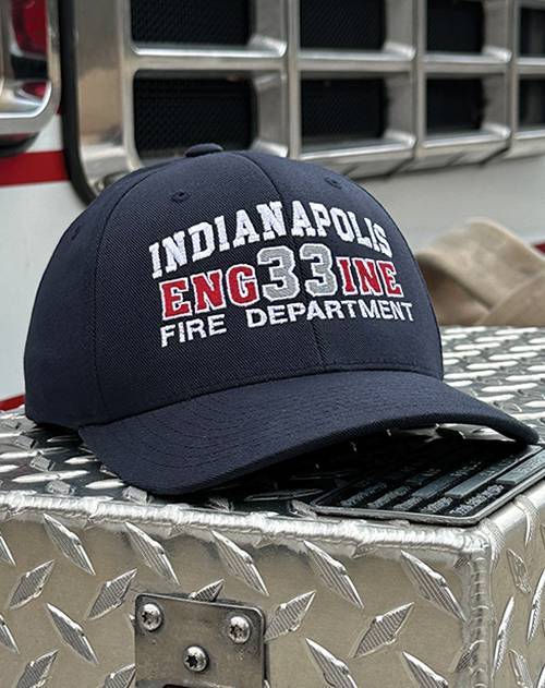 Embroidered "Indianapolis Fire Department" hat on diamond plate surface