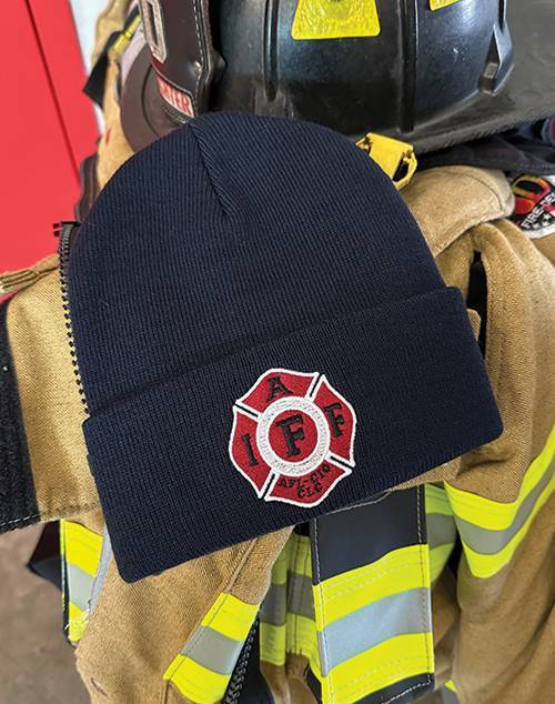 Navy beanie with "IAFF" firefighter insignia displayed on firefighting gear