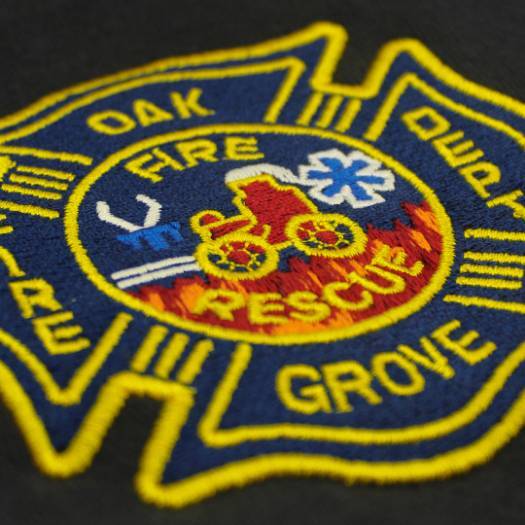 Embroidered "Oak Grove Fire Rescue" patch with emblem on dark fabric