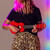 Lifestyle image of the Mad About Red soprano ukulele being played. Lightweight beginner ukulele with carbon strings, geared tuning pegs and a compact 21-inch design, ideal for children, students and first-time players learning chords, strumming and basic techniques.