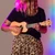 Lifestyle image of the Mad About Peach soprano ukulele being played. Lightweight beginner ukulele with carbon strings, geared tuning pegs and a compact 21-inch design, ideal for children, students and first-time players learning chords, strumming and basic techniques.