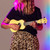 Lifestyle image of the Mad About Pastel Yellow soprano ukulele being played. Lightweight beginner ukulele with carbon strings, geared tuning pegs and a compact 21-inch design, ideal for children, students and first-time players.