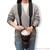 World Rhythm percussion harness carrying a djembe drum in a comfortable playing position, featuring padded shoulder straps and adjustable nylon webbing for musicians.