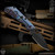 Strider Knives Folder: SnG 3/4 Grind - Black/Flamed Monkey Edge FRAG Pattern