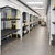 Hospital bed storage lift system with stacked medical beds in a healthcare equipment storage room