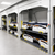 Hospital bed storage lift system with stacked medical beds in a healthcare equipment storage room