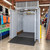 PMB Series vertical pallet lift with open loading doors installed in retail storage area