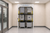 3-Level Vertical Lift Storage Stacker for Laundry, EVS & Janitorial Carts installed along a wall