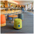 Lifestyle image of MUM Short Roll Active Seating Stool - Cinder Fabric - Dark Wood Base - Dark Chocolate Leather Handle shown in a clean storage environment