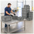 Lifestyle image of Straight Wall Stacking Container - Gray - 175 lb Capacity for small parts storage shown in a clean storage environment