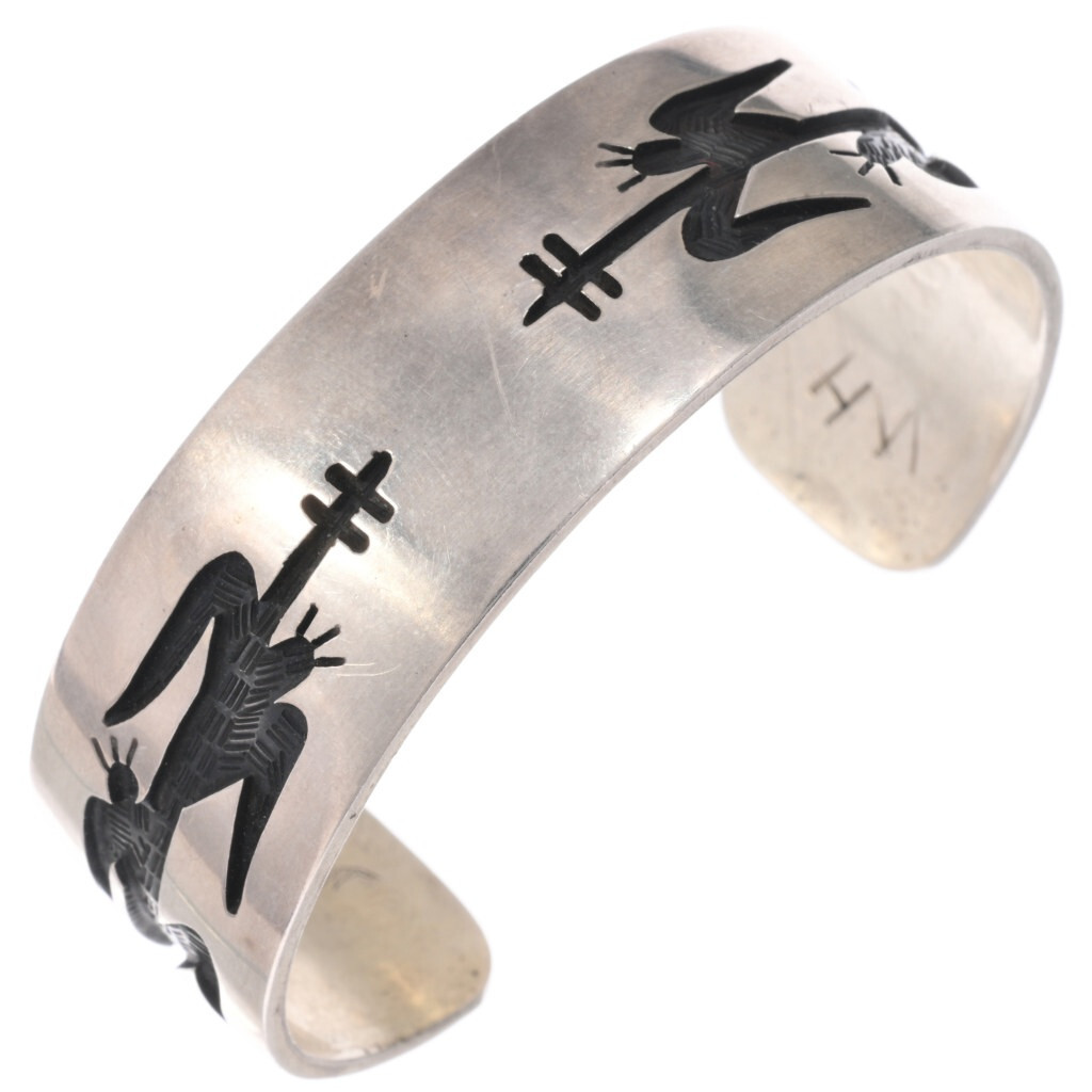 This vintage Hopi overlay bracelet features stylized corn and agricultural imagery, reflecting the deep connection between Hopi culture, the natural world, and the traditions expressed through Native American jewelry.