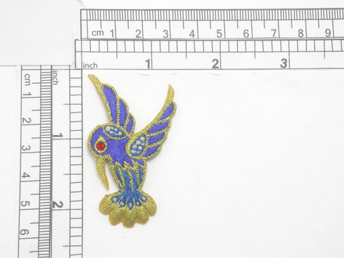 Humming Bird Exotic Gem Eye Bird  Iron On Patch Applique  Measures 2 1/4" high  x 1 3/8" wide

Fully Embroidered with Rayon and Metallic Threads with a Red Faux Gem Eye Accent