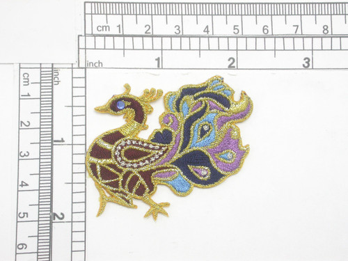 Aves Exotic Gem Eye Bird Iron On Patch Applique
Fully Embroidered in Rayon and Metallic Gold Threads
A small faux gem depicts the eye
Measures 2 1/8" across x 2" high approximately