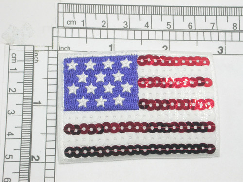 USA Flag Stars & Stripes Sequinned Iron On Patch Applique

Embroidered on Sateen Backing with Rayon Threads and Red and White Sequin Detailing 

Measures 2" high x 2 7/8" wide approximately