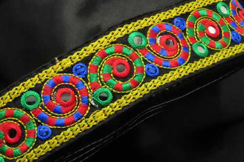 Mirrored Boho Style Embroidered Trim 2 1/8" 54mm Priced Per Yard

Bright Vibrant Thick Embroidery on a black backing - edges are folded and stitched to prevent fraying

Mirrors are a plastic not glass

 