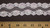 Beaded Galloon Lace 2 1/4" White 
Each large Flower decorated with Clear iridescent sequins and White faux pearl centers

Soft - Price Breaks On Bulk