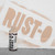 A bottle of Rust-Oleum spray paint in front of a spray-painted logo on a wall.