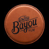 Wholesale engraved Cognac Round Coaster customized with Bayou Rum logo on a black background