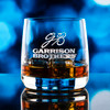 Wholesale engraved 10.5 oz. Sequence Old Fashioned Glass customized with Garrison Brothers Distillers logo on a bokeh background