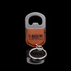 Wholesale engraved Oval Cognac Keychain Bottle Opener customized with St Augustine Distillery logo on a black background