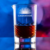 Wholesale engraved Luna Swirl Mixing Glass customized with Casamigos Bar logo on a bokeh background