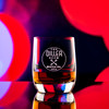 Wholesale engraved 6 oz. Weinland Rocks Glass customized with The Diller Room logo on a bokeh background