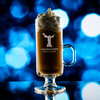 Wholesale engraved 8 oz. Irish Cream Mug customized with Glendalough Distillers logo on a bokeh background
