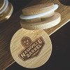 Wholesale engraved Glencairn Barrel Cap customized with Nashville Barrel Company logo on a wood background