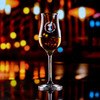 Wholesale engraved Stolzle Tasting Glass customized with Strawberry Thief logo on a bokeh background