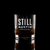 Wholesale engraved 8.5 oz. Stolzle New York Bar Rocks Glass customized with Still Austin Whiskey logo on a black background
