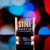 Wholesale engraved 8.5 oz. Stolzle New York Bar Rocks Glass customized with Still Austin Whiskey logo on a bokeh background
