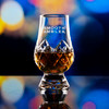 Wholesale engraved Crystal Cut Glencairn Whisky Glass customized with Smooth Ambler logo on a bokeh background