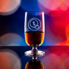 Wholesale engraved Stolzle Tasting Glass #4 customized with Obscure Distillers logo on a bokeh background