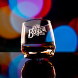 Wholesale engraved 7 oz. Wobble Whisky Glass customized with Bayou Rum Logo bokeh background