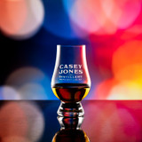 Wholesale engraved Wee Glencairn Glass customized with Casey Jones Distillers logo on a bokeh background