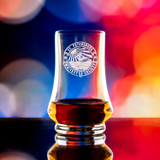 Wholesale engraved Kenzie Whisky Taster Glass customized with St Petersburg logo on a bokeh background