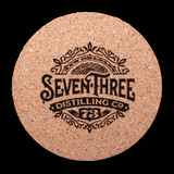 Wholesale engraved Cork Round Coaster customized with Seven Three Distilling logo on  a black background
