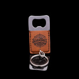Wholesale engraved Square Cognac Keychain Bottle Opener customized with Seven Three Distillery logo on a black background