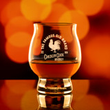 Wholesale engraved 8 oz. Kentucky Bourbon Trail Glass customized with Chicken Cock Whiskey logo on a bokeh background