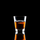 Wholesale engraved 1.75 oz. The Standard Shot Glass customized with Jameson Orange logo on a black background