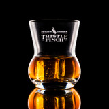 Wholesale engraved 9 oz. Urban Bar Thistle Old Fashioned Glass customized with Thistle Finch Distilling logo on a black background