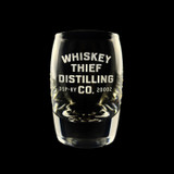 Wholesale engraved 2.5 oz. Urban Bar Barrel Dram Glass customized with Whiskey Thief Distilling logo on a black background
