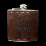 Wholesale engraved 6 oz. Wick·ed Rum Leather Flask customized with Knob Creek logo on a black background