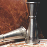 Wholesale engraved Premium Stainless Steel Japanese Jigger customized with St Augustine Distilling logo on a lifestyle background
