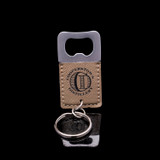 Wholesale engraved Square Tan Keychain Opener customized with Cooperstown Distillery logo on a black background