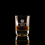 Wholesale engraved 2 oz. Small Batch Shot Glass customized Tarnished Truth Distillers logo on a black background